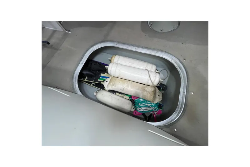 Slide: The Image of Storage compartment in 1999 Four Winns 220 Horizon boat with fenders and ropes. - 21