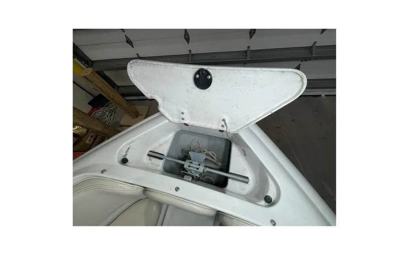 Slide: The Image of Open anchor compartment of 1999 Four Winns 220 Horizon boat in garage. - 22