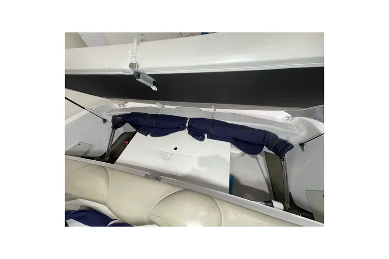 Slide: The Image of 1999 Four Winns 220 Horizon boat interior storage compartment with blue cover. - 24
