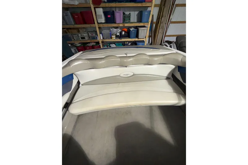 Slide: The Image of 1999 Four Winns 220 Horizon boat interior with beige seating in storage. - 7