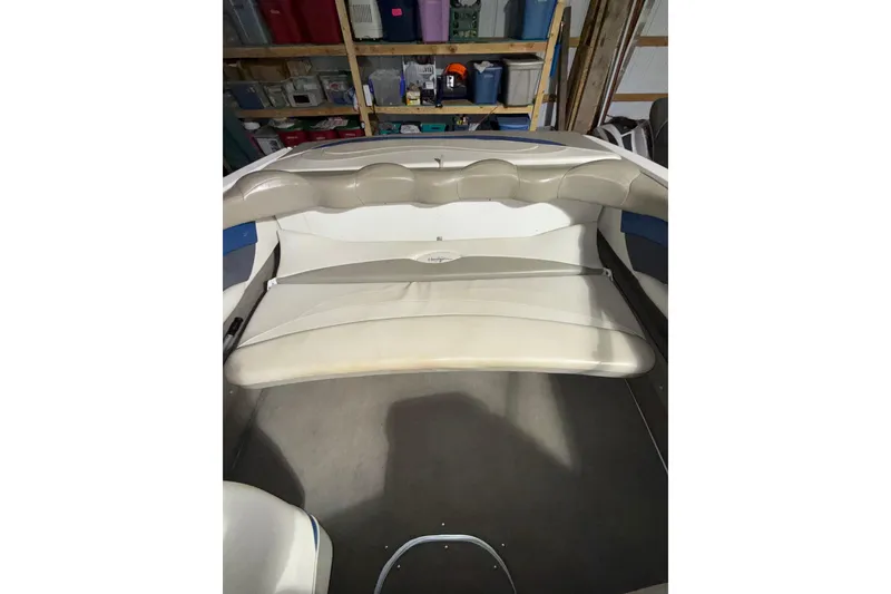 Slide: The Image of 1999 Four Winns 220 Horizon boat interior with beige seating in storage. - 9