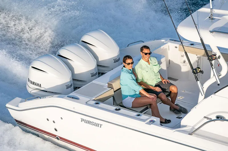 Slide: The Image of Manufacturer Provided Image: Couple enjoying a ride on a 2025 Pursuit OS 355 Offshore boat. - 16