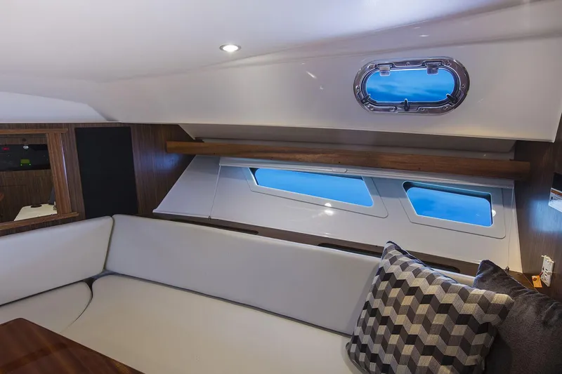 Slide: The Image of Manufacturer Provided Image: Luxurious interior of 2025 Pursuit OS 355 Offshore yacht with modern seating and windows. - 24