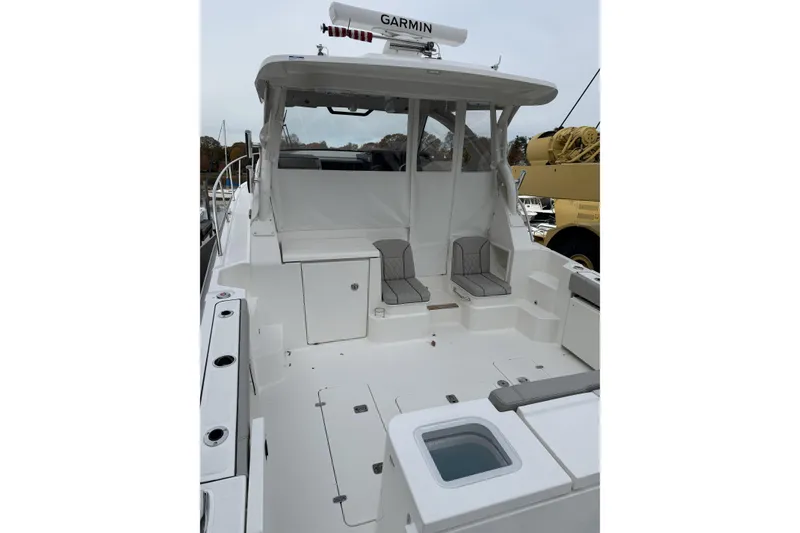 Slide: The Image of 2026 Pursuit OS 355 Offshore boat interior with seating and storage compartments. - 4