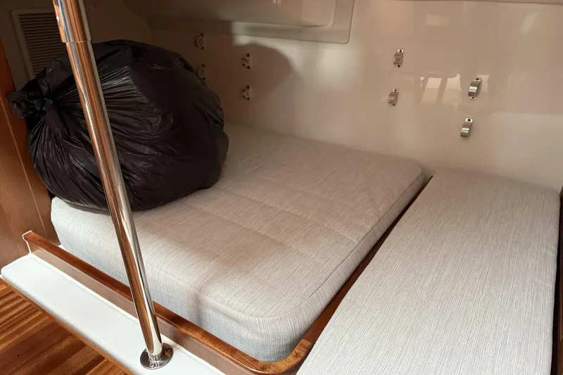 Slide: The Image of Interior cabin of 2026 Pursuit OS 355 Offshore boat with cushioned seating. - 8