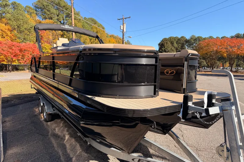 Slide: The Image of 2026 Veranda VR 265 VL Blackout Edition pontoon boat on trailer, surrounded by autumn trees. - 4