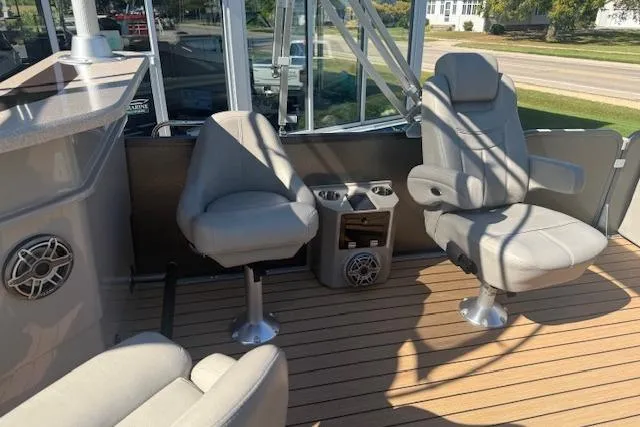 Slide: The Image of 2019 Premier 260 Grand Entertainer boat interior with comfortable seating and cup holders. - 10