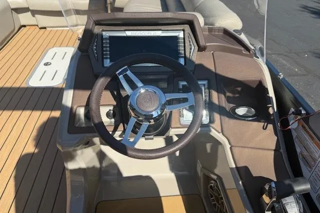 Slide: The Image of Steering console of 2019 Premier 260 Grand Entertainer boat with modern controls. - 12