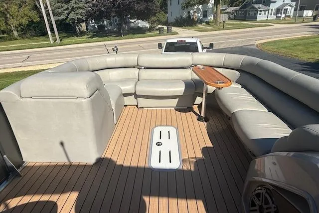 Slide: The Image of 2019 Premier 260 Grand Entertainer pontoon boat with spacious seating and wooden deck. - 13