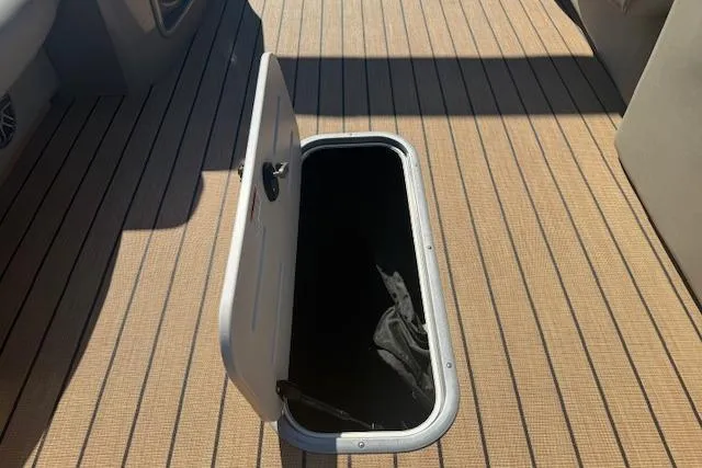 Slide: The Image of Open storage compartment on 2019 Premier 260 Grand Entertainer boat deck. - 14