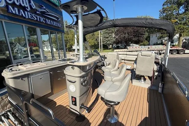 Slide: The Image of 2019 Premier 260 Grand Entertainer pontoon boat with luxurious seating and bar area. - 4
