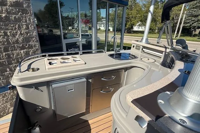 Slide: The Image of 2019 Premier 260 Grand Entertainer boat with outdoor kitchen and sleek design. - 6