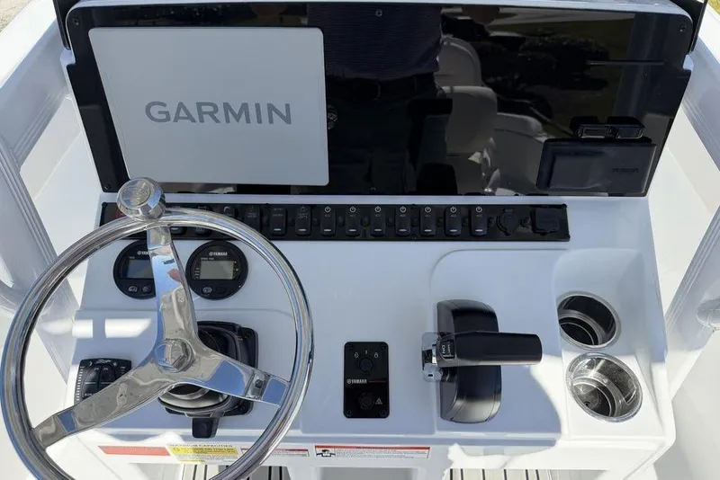 Slide: The Image of 2026 Sea Hunt Ultra 235 SE boat interior with cushioned seating and sleek design. - 11