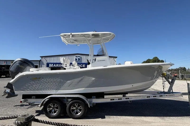 Slide: The Image of 2026 Sea Hunt Ultra 235 SE boat on trailer, Yamaha engine, at marine service center. - 3