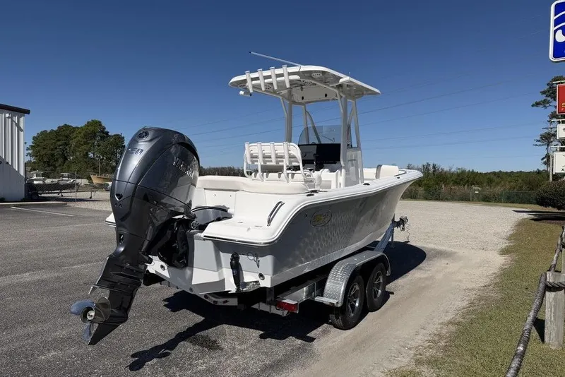 Slide: The Image of 2026 Sea Hunt Ultra 235 SE boat on trailer outside marine service center. - 5