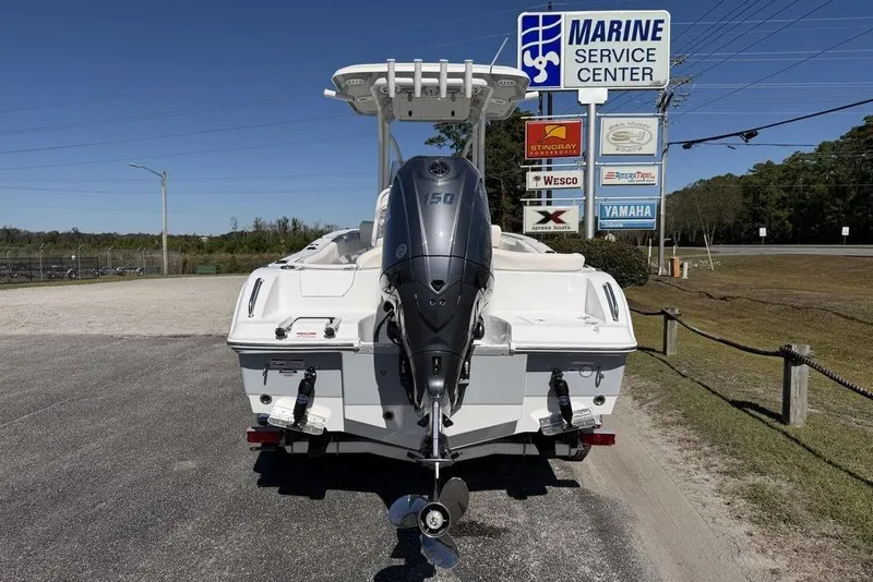 Slide: The Image of 2026 Sea Hunt Ultra 235 SE boat displayed outdoors under a sunny sky. - 7