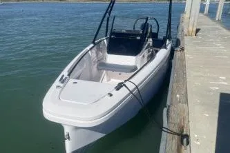 Slide: The Image of 2022 Axopar 22 TT boat docked on calm water. - 11