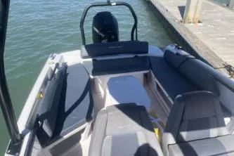 Slide: The Image of 2022 Axopar 22 TT boat with sleek seating, docked by the water. - 15