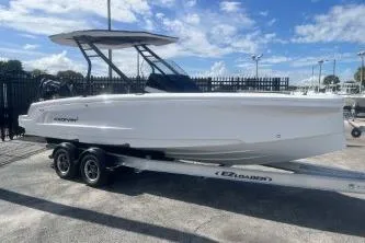 Slide: The Image of 2022 Axopar 22 TT boat on trailer under blue sky. - 2