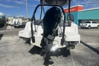 Slide: The Image of 2022 Axopar 22 TT boat with outboard motor, parked outdoors. - 5