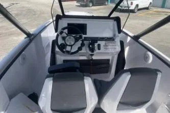 Slide: The Image of 2022 Axopar 22 TT boat cockpit with modern steering and seating. - 7