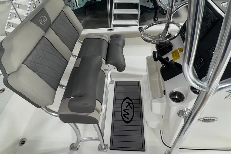 Slide: The Image of Interior of 2026 Key West 230 Bay Reef boat with steering wheel and seating. - 12