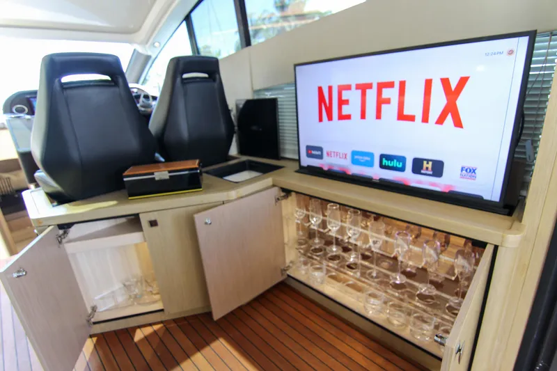 Slide: The Image of Luxurious Sunseeker Predator 57 yacht interior with TV and glassware cabinet, 2017 model. - 29