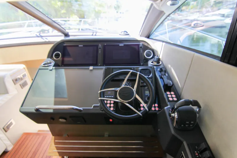 Slide: The Image of Cockpit of 2017 Sunseeker Predator 57 yacht with modern controls and steering wheel. - 32