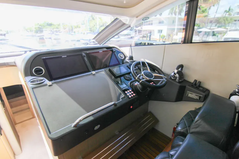 Slide: The Image of Helm of 2017 Sunseeker Predator 57 yacht with modern controls and navigation screens. - 33