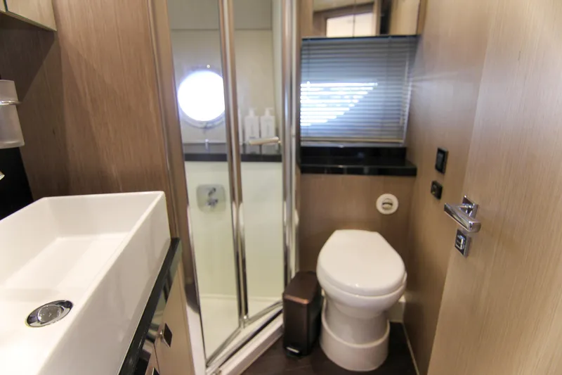 Slide: The Image of Luxurious bathroom in 2017 Sunseeker Predator 57 yacht with modern fixtures and porthole window. - 38