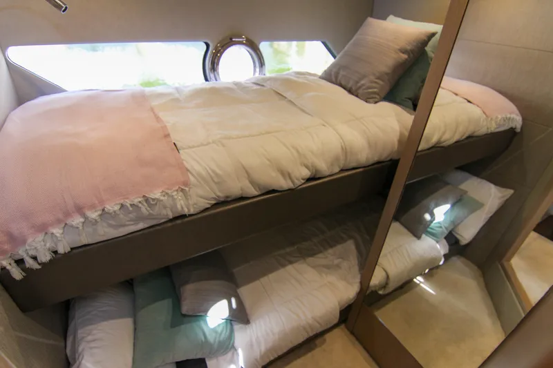 Slide: The Image of Bunk beds in 2017 Sunseeker Predator 57 yacht cabin, featuring cozy bedding and modern design. - 47