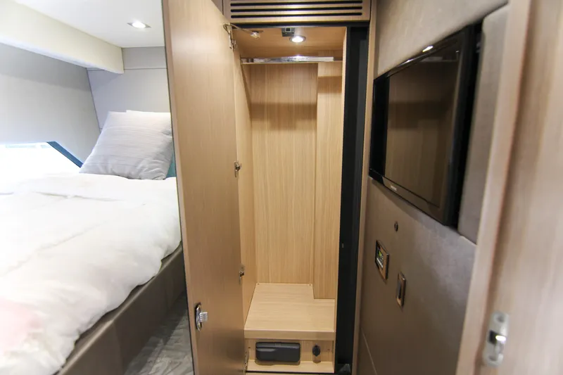 Slide: The Image of Interior of 2017 Sunseeker Predator 57 yacht, featuring a wooden wardrobe and cozy bedroom. - 48