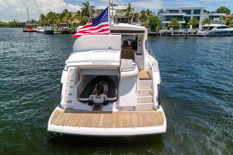 Slide: The Image of 2017 Sunseeker Predator 57 yacht with American flag, docked in Boca Raton, Florida. - 54