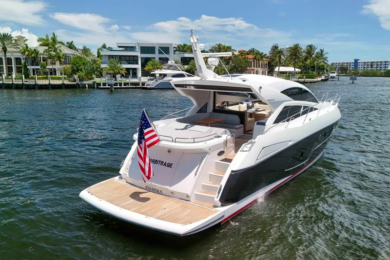 Slide: The Image of 2017 Sunseeker Predator 57 yacht cruising in a scenic waterfront setting. - 56