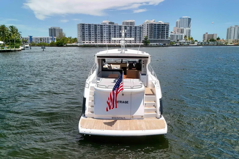 Slide: The Image of Sunseeker Predator 57 yacht, 2017 model, cruising in a scenic waterfront cityscape. - 57