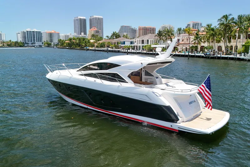 Slide: The Image of 2017 Sunseeker Predator 57 yacht cruising near waterfront cityscape. - 58