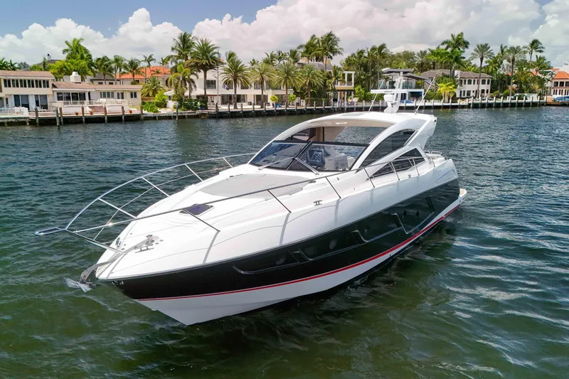 Slide: The Image of 2017 Sunseeker Predator 57 yacht cruising near luxury waterfront homes. - 59