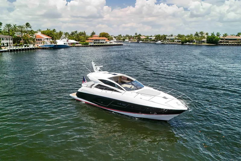 Slide: The Image of 2017 Sunseeker Predator 57 yacht cruising on a scenic waterfront. - 62