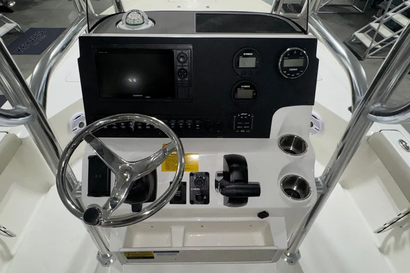Slide: The Image of 2026 Key West 230 Bay Reef boat console with steering wheel, gauges, and navigation controls. - 17