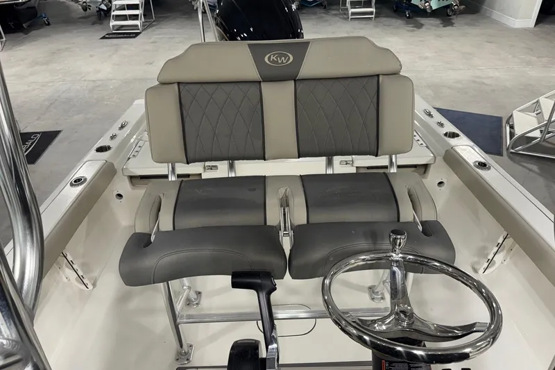 Slide: The Image of 2026 Key West 230 Bay Reef boat interior with dual seats and steering wheel. - 11