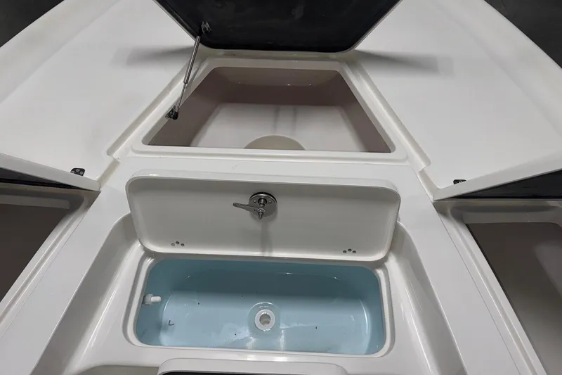 Slide: The Image of 2026 Key West 230 Bay Reef boat storage compartments and livewell. - 7