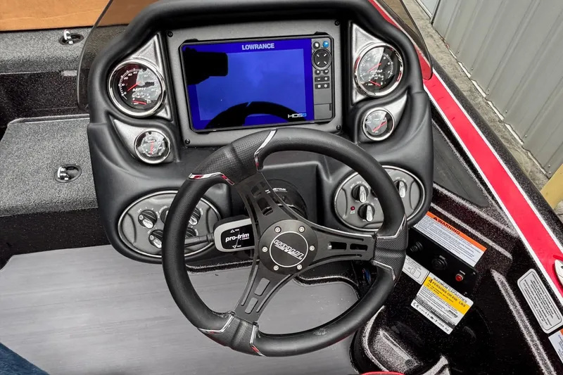 Slide: The Image of Dashboard of 2026 Triton 19 TrX Patriot boat with steering wheel and digital display. - 10