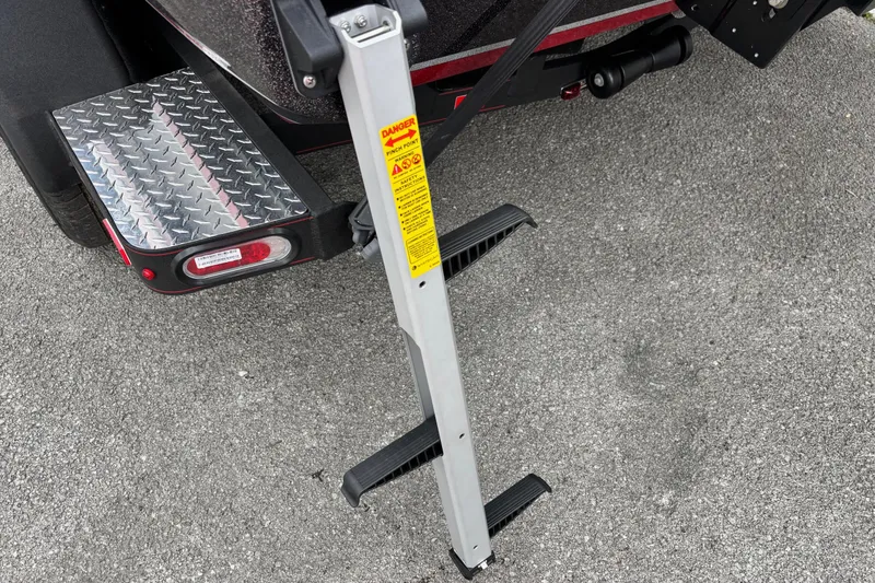 Slide: The Image of Trailer step ladder on a 2026 Triton 19 TrX Patriot boat trailer. - 15