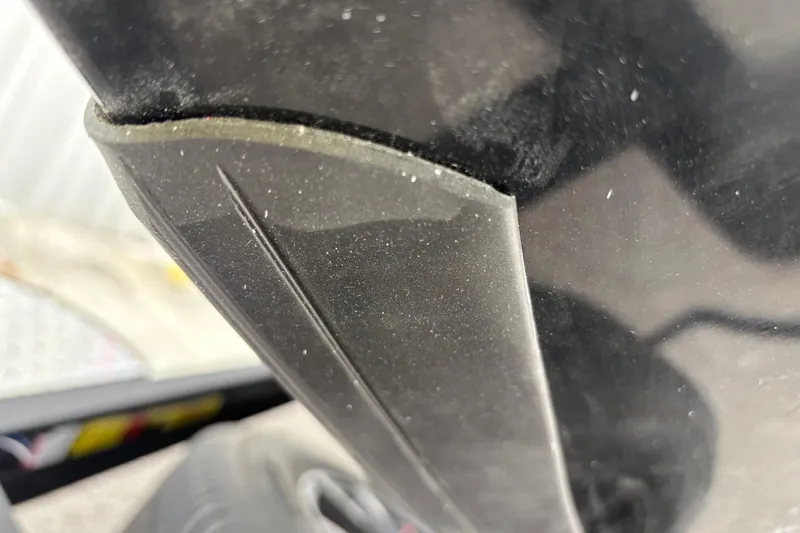 Slide: The Image of Close-up of 2026 Triton 19 TrX Patriot boat detail, showcasing sleek black surface. - 2