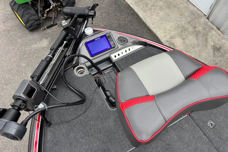 Slide: The Image of 2026 Triton 19 TrX Patriot boat interior with seat, control panel, and trolling motor. - 5