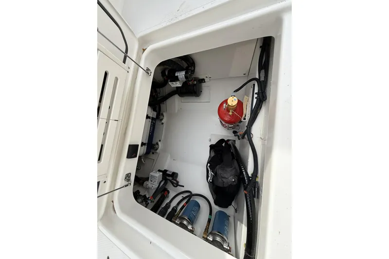 Slide: The Image of 2026 Pursuit OS 325 Offshore engine compartment with fire extinguisher and equipment. - 3