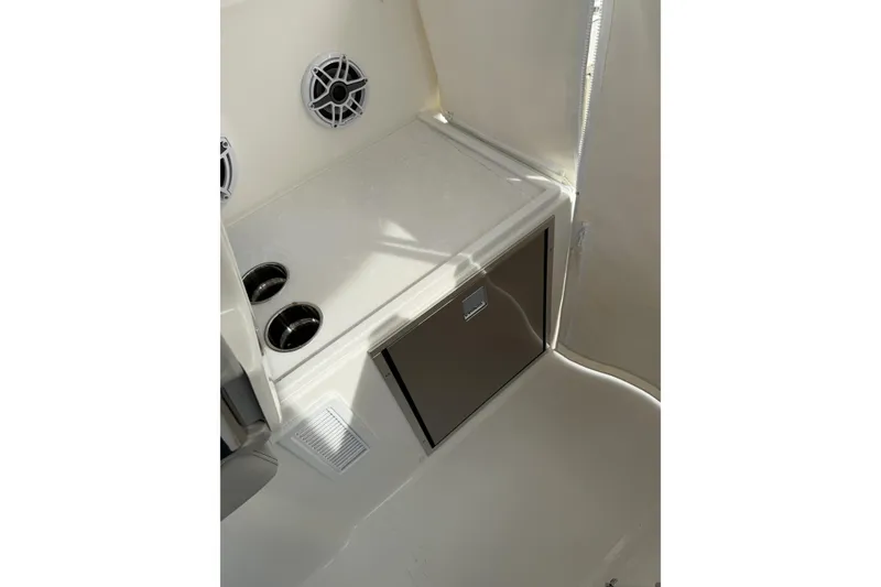 Slide: The Image of 2026 Pursuit OS 325 Offshore boat interior with storage and cup holders. - 5