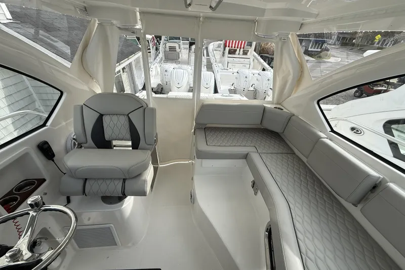 Slide: The Image of 2026 Pursuit OS 325 Offshore boat interior with luxurious seating and modern design. - 6