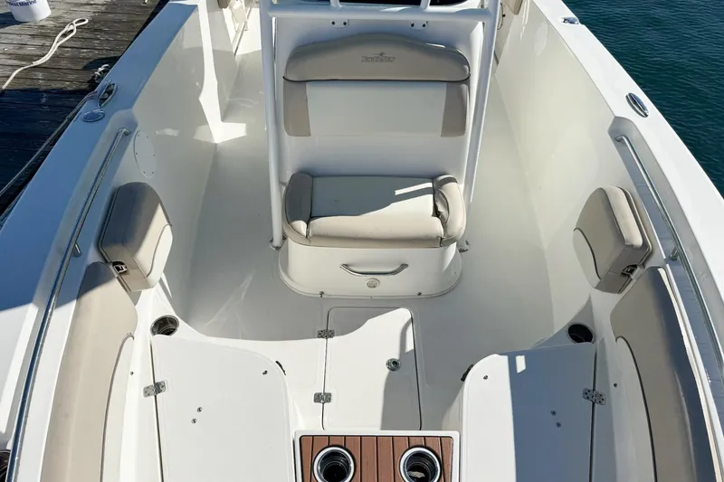 Slide: The Image of 2017 NauticStar 2602 Legacy boat interior with cushioned seating and storage compartments. - 10