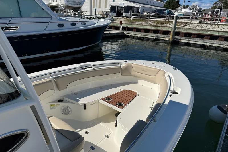 Slide: The Image of 2017 NauticStar 2602 Legacy boat docked, featuring spacious seating and sleek design. - 12